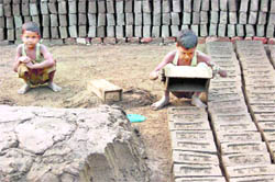 Child labourers work at a kiln on Childrens Day eve on the outskirts of Sivasagar, Assam, on Saturday