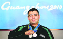 Ace shooter Gagan Narang shows two silver medals that he won in Guangzhou on Saturday. 