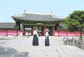 Korean women in their traditional dress (hanbok) guide visitors through the 15th century Changdeokgung palace built during the Joseon reign