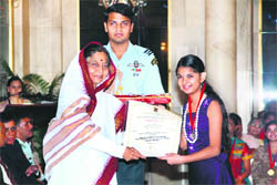 Harkiran Kaur of Manav Mangal Smart School, Mohali, receives the National Child Award for Excellence from President Patibha Patil at New Delhi on Sunday. 