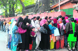 People stand in a queue to meet Chief Minister 
