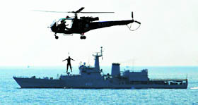 A Navy Chetak helicopter demonstrates a search and rescue mission as the destroyer INS Ranjit sails in the background in the waters off the Bay of Bengal near Paradeep, some 150 km from Bhubaneswar, on Sunday. Ships from the Eastern Fleet demonstrated their capabilities as part of Navy Week.