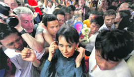 Suu Kyi leaves the National League for Democracy office after conducting her first press conference since her release in Yangon on Sunday.