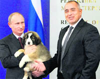 Russian Prime Minister Vladimir Putin cuddles a Bulgarian Karakachanka sheepdog puppy, a gift from his Bulgarian counterpart Boiko Borisov, after signing the agreements on the South Stream gas transit pipeline in Sofia, Bulgaria.