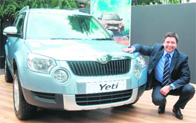 Skoda Auto India Board Member & Director, Sales & Marketing, Thomas Kuehl poses next to the company's new car Yeti during its launch in New Delhi on Monday. Skoda Yeti is powered by a 2.0 TDI common rail diesel engine that does duty in Superb and Laura. The car is priced between Rs 15 lakh and Rs 18 lakh