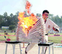 An ITBP commando performs a martial art act at the ITBP passing-out parade in Dehradun on Monday