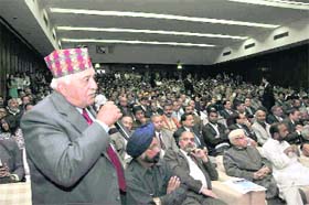 Former Tourism Minister Lt Gen TPS Rawat (retd) poses a question to Ratan Tata, Chairman of the Tata group
