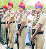 Constables of the Haryana Police reverse their arms as homage to Arjuna awardee Balwant Singh, former Indian volleyball team captain, at Kaul village in Kaithal on Sunday.