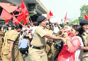 The police arrests Shiv Sena activists protesting against Adarsh housing society scam in Mumbai on Monday.