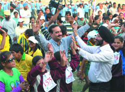 Mentally challenged children dance with their parents at the conclusion of the Punjab State Special Olympics in Hoshiarpur