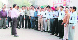 The Indian Institute of Insurance Surveyors and Loss Assessors wear black badges as a mark of protest. 