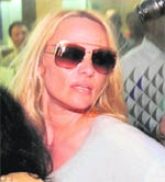 US model and actor Pamela Anderson after she arrives at the international airport in Mumbai on Monday. Anderson will participate as a celebrity guest in the 4th season of Bigg Boss.