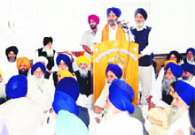 Deputy Chief Minister Sukhbir Singh Badal addresses a meeting of SGPC members in Teja Singh Samundari Hall in Amritsar on Monday. 