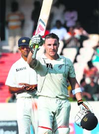 New Zealand batsman Brendon McCullum raises his bat after his century during the second Test in Hyderabad