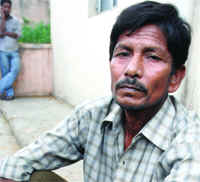 Jatin Halder, a rickshaw puller, waits at the mortuary of the Lok Nayak Jai Prakash Hospital to receive the body of his 16-year-old son Sapan.