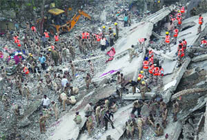 Rescue work in progress at the site where a five-storeyed building collapsed at Laxmi Nagar in New Delhi on Tuesday. 