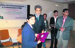 Neha Chauhan of Dehradun Hills Academy being awarded by Dr Rakesh Shankar at a seminar in Dehradun. 