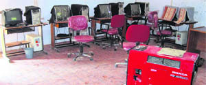 Computers and a generator set lie idle at Model Girls Middle School in Jammu. 