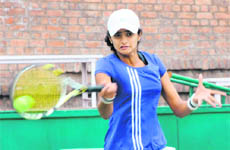 Devanshi returns a shot during a tennis match at the CLTA in Chandigarh on Wednesday.