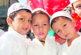 Children show off the balloons that they bought after Eid prayers in Dehradun on Wednesday.