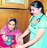 Nirmala with her newborn at Guru Nanak Hospital