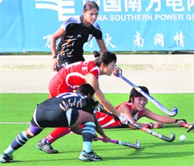 Indian women hockey players in action against South Korea in Guangzhou