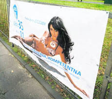 An election banner of Sara May, a polish singer and tabloid celebrity, is seen on a street in Warsaw. May, whose real name is Katarzyna Szczolek, has put up posters of herself stretched out on the sand in a provocative bikini as part of her campaign to win a Warsaw district council seat in municipal elections on November 21.