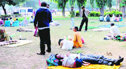 Patients and attendants lying in the open on the PGI campus on Thursday. 