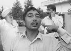 Truck driver Pardeep Kumar shows his injuries at the Baltana police chowki on Thursday. 