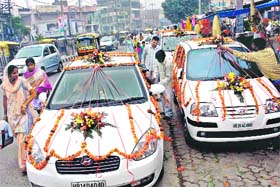 Florists decorate cars to be used by newlywed after wedding ceremonies in Rohtak
