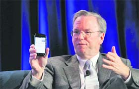 Google CEO Eric Schmidt holds a prototype of the Android Gingerbread smartphone during the Web 2.0 Summit in San Francisco, California on November 15, 2010
