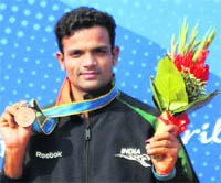 Vijay Kumar posing for a picture after winning bronze in mens 25m centre fire pistol event at Aoti Shooting Range