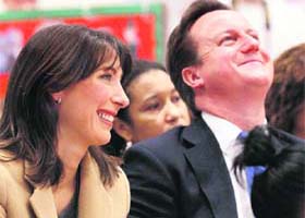British Prime Minister David Cameron (R) and his wife Samantha visit the Jack Tizard School, a day school for pupils with a range of severe learning difficulties, in London