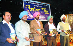 Deputy Commissioner K.S. Pannu (centre) releases books of Dr Vikramjit and Shiromani Kavi Parminderjit during a function in Amritsar.