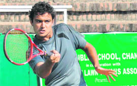A player returns a shot during a tennis match at the CLTA in Chandigarh on Friday.