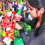 A girl arranges flowers during a flower arrangement competition at the PEC fest in Chandigarh on Friday.