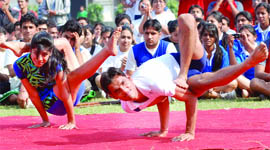 Students perform yoga at the sports meet of GGSIPU in New Delhi on Friday.
