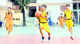 A match in the junior boys basketball tournament being played at The Heritage School in Dehradun on Friday.