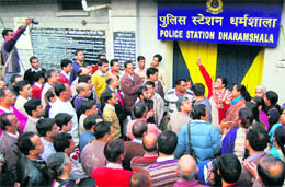 The Himachal Pradesh Board of School Education employees hold a protest in front of police station in Dharamsala on Friday