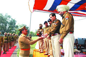 A trainee being honoured at the passing out parade in Punjab Police Academy in Phillaur on Friday