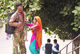 A girl begs for alms from a passenger at the Jammu Railway Station.