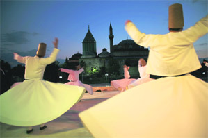 Dervish performers swirling at the Mevlana Museum, Turkey