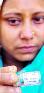 A woman shows the expired vaccine