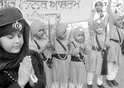 Children take part in a Nagar Kirtan on the eve of the birth anniversary of 