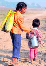 Two-year-old Satnam Singh along with his sister walks barefeet to cover 2 km to reach their shelter on the banks of the Sutlej in Ludhiana.