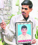 Jatinder Kumar holds the picture of his brother, Pulinder, who was shot dead by Jarnail Singh in Ludhiana.