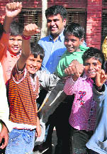 Rahul Gupta, a student of German department, PU, with poor children.