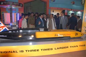 Haryana Chief Minister Bhupinder Singh Hooda looks at a model of JCB Diesel Max Car displayed at Haryana Pavilion of the India International Trade Fair in New Delhi