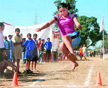 A girl attempts a long jump at the panchayat games in Dehradun on Sunday