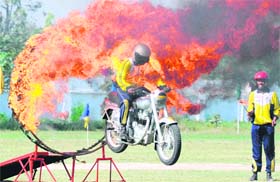A daredevil motorcyclist shows his skills during the Old Boys Golden Jubilee Meet at Sainik School, Kunjpura